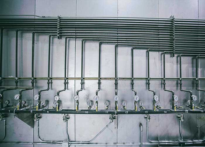 A close-up view of a bank of industrial-style valves and gauges, showcasing the intricate details of the equipment.