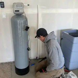 An image of a person working on a water filtration system
