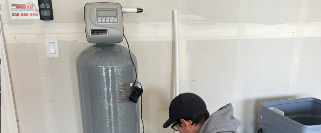 An image showing a water softener system with a control panel and various components.