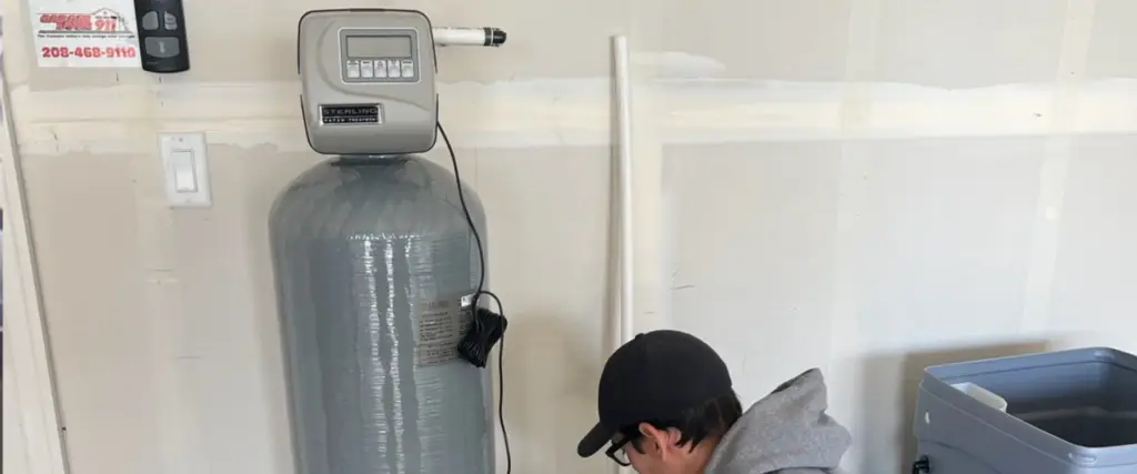 An image showing a water softener system with a control panel and various components.